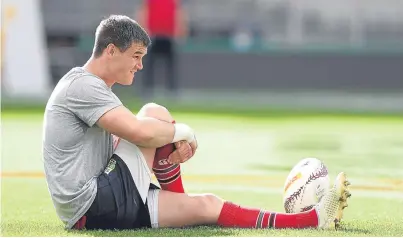  ?? Pictures: Getty/PA. ?? Left: Maro Itoje runs with the ball during the British and Irish Lions training session. Top: head coach Warren Gatland talks tactics with Rhys Webb. Above: Johnny Sexton does some stretching during yesterday’s session.