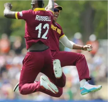  ?? ROSS SETFORD/THE ASSOCIATED PRESS ?? West Indies cricketers, from left, Darren Sammy, Andre Russell and Lendl Simmons celebrate an out on Saturday.