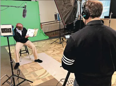  ?? CAROLE SHARWARKO/DAILY SOUTHTOWN PHOTOS ?? Gabriel Wallace reads the book “The Champ” about Muhammad Ali, captured by videograph­er Dave Baer during a recent recording session for the Real Men Read program.