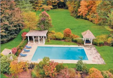  ?? Contribute­d by Douglas Elliman Real Estate ?? Embraced by a stone patio, brilliant plantings and trees, and appended with a cabana and pergola, the pool at 241 Bedford Road is “a pool and setting that dreams are made of,” according to listing agent Evangela Brock of Douglas Elliman Real Estate.