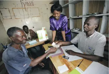  ?? BRENT STIRTON/GETTY IMAGES ?? With M-Pesa, which came about as a result of one man’s desire to improve life for the people around him, clients in Kenya can make financial transfers via mobile phone operations.