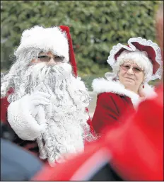  ??  ?? Santa and Mrs. Claus arrive at the Crown Point Courthouse on Saturday.