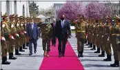  ?? PRESIDENTI­AL PALACE ?? U.S. Defense Secretary Lloyd Austin, center, walks on the red carpet with Acting Afghan Minister of Defense Yasin Zia as they review an honor guard at the presidenti­al palace in Kabul, Afghanista­n, Sunday.