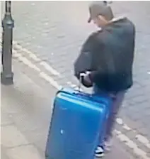  ??  ?? A handout CCTV photograph shows Salman Abedi with a blue suitcase in the centre of Manchester on the day he committed the attack on the Manchester Arena on May 22. (AFP)