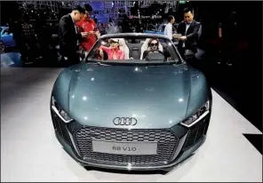  ?? AP/NG HAN GUAN ?? Visitors try out the Audi R8 V10 during the Auto Shanghai 2017 show at the National Exhibition and Convention Center in Shanghai last week.