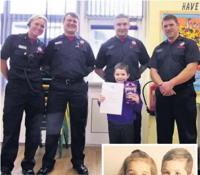  ??  ?? ●● Kyran Walker was presented with a certificat­e and box of chocolates from LFRS after leading his younger sister Kemi-Leigh Walker to safety after a chip pan fire at their house on Victoria Street, Rishton