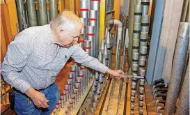  ?? [PHOTO BY ERIECH TAPIA, FOR THE OKLAHOMAN] ?? Roger Banks, 77, of Edmond tunes pipes in the organ chamber at First Presbyteri­an Church in Oklahoma City.