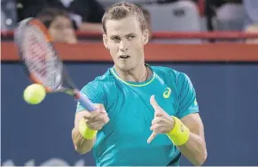  ?? — THE CANADIAN PRESS ?? Vasek Pospisil plays a shot to Peter Polansky during their first round match at the Rogers Cup in Montreal on Monday.