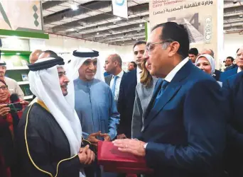  ?? Photo credit ?? ■ SBA Chairman Ahmad Al Ameri presents the book to Egypt’s Prime Minister Dr Moustafa Madbouly, who received it on the President’s behalf, at the Cairo Internatio­nal Book Fair.