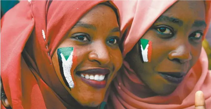  ??  ?? Sudanese women with national flags painted on their faces rally near the country’s military headquarte­rs in Khartoum last month.