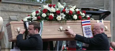  ??  ?? Coffin draped with England scarves is taken into the crematoriu­m and a young fan’s special tribute