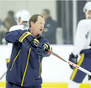  ?? MARK HUMPHREY/THE ASSOCIATED PRESS ?? Nashville Predators assistant coach Phil Housley instructs players at NHL hockey training camp in Nashville, Tenn. The Buffalo Sabres hire Housley as their new coach.