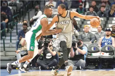  ?? AP Photo/Tony Gutierrez ?? ■ Dallas Mavericks forward Reggie Bullock, left, defends Tuesday as Brooklyn Nets forward Kevin Durant (7) works for a shot in the first half of an NBA game in Dallas.
