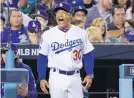  ?? MATT SLOCUM/AP ?? Los Angeles Dodgers manager Dave Roberts, seen here arguing a call against the Brewers, is a former Boston player.