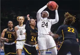  ?? ASSOCIATED PRESS ?? NOTRE DAME’S Arike Ogunbowale (24) goes up for a shot between Bethune-Cookman’s Angel Golden (24) and Tania White (22) during a first-round game in the NCAA women’s college basketball tournament in South Bend, Ind., Saturday. No. 8 CALIFORNIA 92, No. 9 NORTH CAROLINA 72