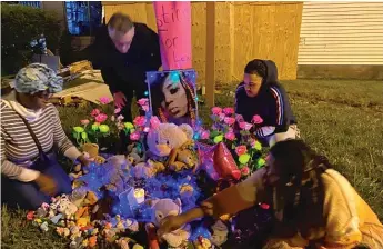  ?? PROVIDED BY WILSON FAMILY ?? Community members gather at a memorial set up for Alexis Wilson near the site of the crash.