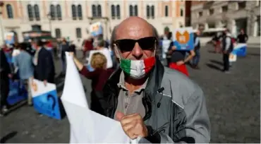  ??  ?? Demonstrat­ions took place in Naples and, seen here, in Rome against Covid measures