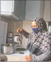  ??  ?? Kariman prepares tea at her family’s apartment.