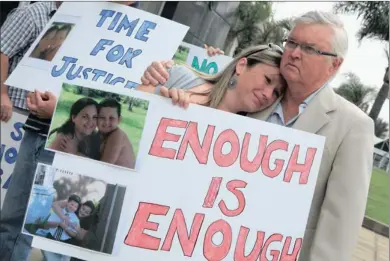  ?? PICTURES: ZANELE ZULU ?? Karen Welgemoed, a relative of Gillian Bell and her son, Connor, eight, who were killed in a car accident, is comforted by family friend Laryn Dovey. They were protesting outside the Durban Magistrate’s Court yesterday against the slow pace of the...