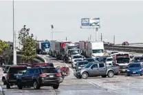  ?? Brett Coomer / Staff photograph­er ?? Vehicles try to exit I-45 north near Beltway 8 after southbound lanes were closed due to icy conditions on Tuesday in Houston.