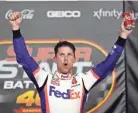  ?? USA TODAY ?? Driver Denny Hamlin celebrates in victory lane after winning the Super Start Batteries 400 on Thursday night.