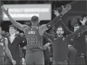  ?? The Associated Press ?? LONG LIVE THE KING: LeBron James celebrates with the Cavaliers Wednesday after they defeated the Toronto Raptors, 132-129, in Cleveland. James finished with 35 points, 17 assists and zero turnovers in 40 minutes.