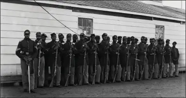  ?? (Courtesy of Library of Congress) ?? The fourth company of Black soldiers at Fort Lincoln is shown in “Our America: A Photograph­ic History.” The 1863 Militia Act allowed Black men to become part of the army, albeit segregated. About 180,000 Black men fought in the Union army and 20,000 in the Union navy.