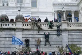  ?? JOSE LUIS MAGANA — AP PHOTO ?? Supporters of President Donald Trump climb the west wall of the the Capitol on Wednesday during an invasion of the building while Congress was in session.