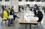  ?? ASSOCIATED PRESS FILE PHOTO ?? Election workers, right, verify ballots as recount observers, left, watch during a Milwaukee hand recount of presidenti­al votes at the Wisconsin Center in Milwaukee.