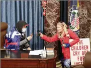  ?? GETTY IMAGES ?? Christine Priola became a suspect in the Capitol riots after a photograph­er took a picture of protesters in the chamber of the U.S. Senate. People on social media identified the woman as Priola.