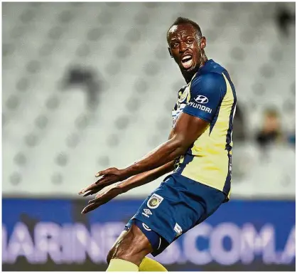  ?? — AFP ?? For real?: Usain Bolt in action with A-League side Central Coast Mariners during a pre-season friendly against Macarthur South West United in Sydney on Friday.