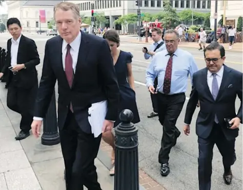  ?? LUIS ALONSO LUGO/AP FILES ?? U.S. Trade Representa­tive Robert Lighthizer, front left, and Mexican Secretary of Economy Ildefonso Guajardo Villarreal, front right, walk to the White House late last month. Lighthizer says there was still “some distance” on issues with Canada hindering a trade deal.