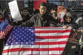  ?? VICTOR J. BLUE/THE NEW YORK TIMES 2017 ?? People gather in New York City’s Foley Square to protest the Trump administra­tion’s travel ban late last month. The Supreme Court said Friday it would review a federal appellate court’s ruling against the ban.