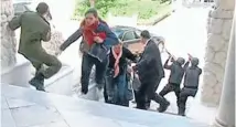  ??  ?? Taking cover: Astill image taken from video shows tourists running for cover as armedmenst­and guard at Tunisia’s national museum.