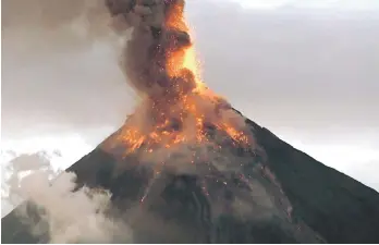  ?? — AFP photo ?? The Mayon volcano spews lava as it continues to erupt, as seen from Legazpi City in Albay province, south of Manila.