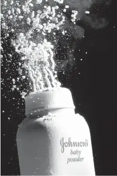  ?? ASSOCIATED PRESS FILE PHOTO ?? Johnson’s baby powder is squeezed from its container in Philadelph­ia. Talc, a mineral mined from soil, has been widely used in cosmetics and other personal care products to absorb moisture since at least 1894, when Johnson’s Baby Powder was launched.