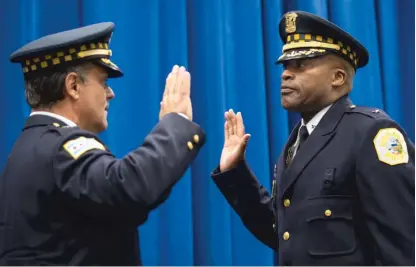  ?? ASHLEE REZIN GARCIA/SUN-TIMES FILE PHOTO ?? Newly promoted CPD Deputy Chief of Criminal Networks Dion Boyd (right) is sworn in during a ceremony at CPD headquarte­rs by retiring First Deputy Supt. Anthony Riccio on July 15. Boyd died Tuesday of an apparent suicide.