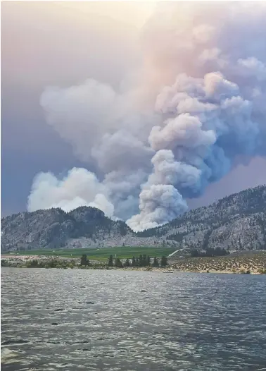  ?? TWITTER @DYLANGALEA­S VIA REUTERS ?? A wildfire near Osoyoos, B.C., sparked Monday has forced evacuation­s between the south Okanagan towns of Oliver and Osoyoos. It's one of 300 burning in the province.