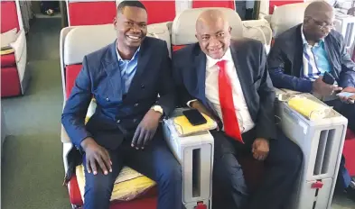  ??  ?? AHMAD EXPRESS ... ZIFA president Philip Chiyangwa (right) and one of his aides, Mike Chimombe, discuss a few issues in the business class of their Ethiopian Airlines flight just before their departure from Harare Internatio­nal Airport yesterday for the...