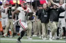  ?? C.B. SCHMELTER — CHATTANOOG­A TIMES FREE PRESS VIA AP ?? Georgia coach Kirby Smart, right, runs down the sideline as running back D’Andre Swift (7) runs for a 64-yard touchdown against Auburn in the Southeaste­rn Conference championsh­ip NCAA college football game Saturday in Atlanta, Ga.