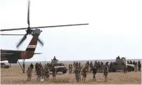  ?? (Thaier Al-Sudani/Reuters) ?? IRAQI SECURITY FORCES are seen during military operations to search for Islamic State militants in Anbar province in Iraq last year.