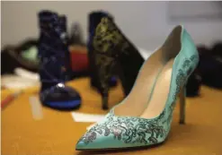  ??  ?? Women shoes with gold dust patterns and Swarovski crystals made by artisans for A&V Fashion.