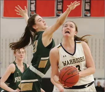  ?? PHOTO BY PAUL CONNORS — MEDIA NEWS GROUP/BOSTON HERALD ?? Andover’s Anna Foley, right, drives to the basket past Bishop Feehan’s Julia Webster during the fourth quarter of their IAABO 27 Comcast Tournament semifinal. Andover won, 48-42.