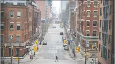  ?? PETER J. THOMPSON ?? A pedestrian walks in the empty streets of Toronto on Thursday. There hasn’t been a rise in formal bankruptcy filings.