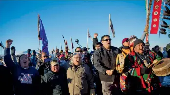  ?? — AP ?? Protesters at Oceti Sakowin camp, North Dakota, on Sunday. The US Army Corps of Engineers has nixed plans for a controvers­ial oil pipeline crossing in North Dakota, a major victory for Native Americans and environmen­talists, who had staged months of...