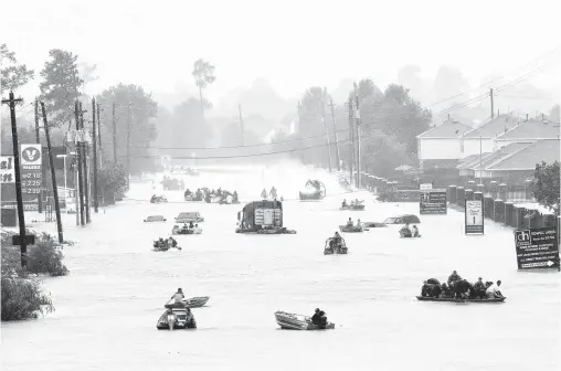  ?? Melissa Phillip / Houston Chronicle file ?? Practicall­y anyone with a boat, it seemed, helped rescue stranded Harvey victims, as this photo taken last August at flooded Tidwell Road shows.