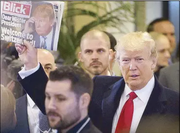  ?? EPA ?? US President Donald Trump holds up Swiss newspaper Blick as he arrives at the Congress Center on the last day of the 48th annual meeting of the World Economic Forum (WEF) in Davos, Switzerlan­d on Friday.