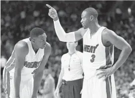  ?? JIM RASSOL/STAFF FILE PHOTO ?? Heat guard Dwyane Wade (3) and forward Luol Deng face a Monday deadline to decide whether to opt-in to their Heat contracts.