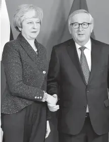  ?? AP ?? European Commission President Jean-Claude Juncker shakes hands with British Prime Minister Theresa May before their meeting at the European Commission headquarte­rs in Brussels, yesterday.