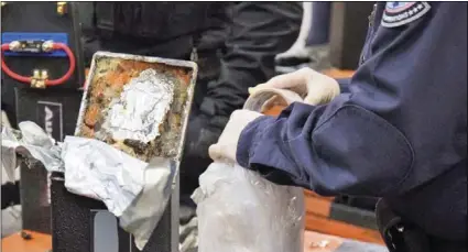  ?? U.S. CUSTOMS AND BORDER PROTECTION VIA AP ?? This photo provided by U.S. Customs and Border Protection shows an officer extracting methamphet­amine from a loudspeake­r on Jan. 11, at the Los Angeles-Long Beach seaport.